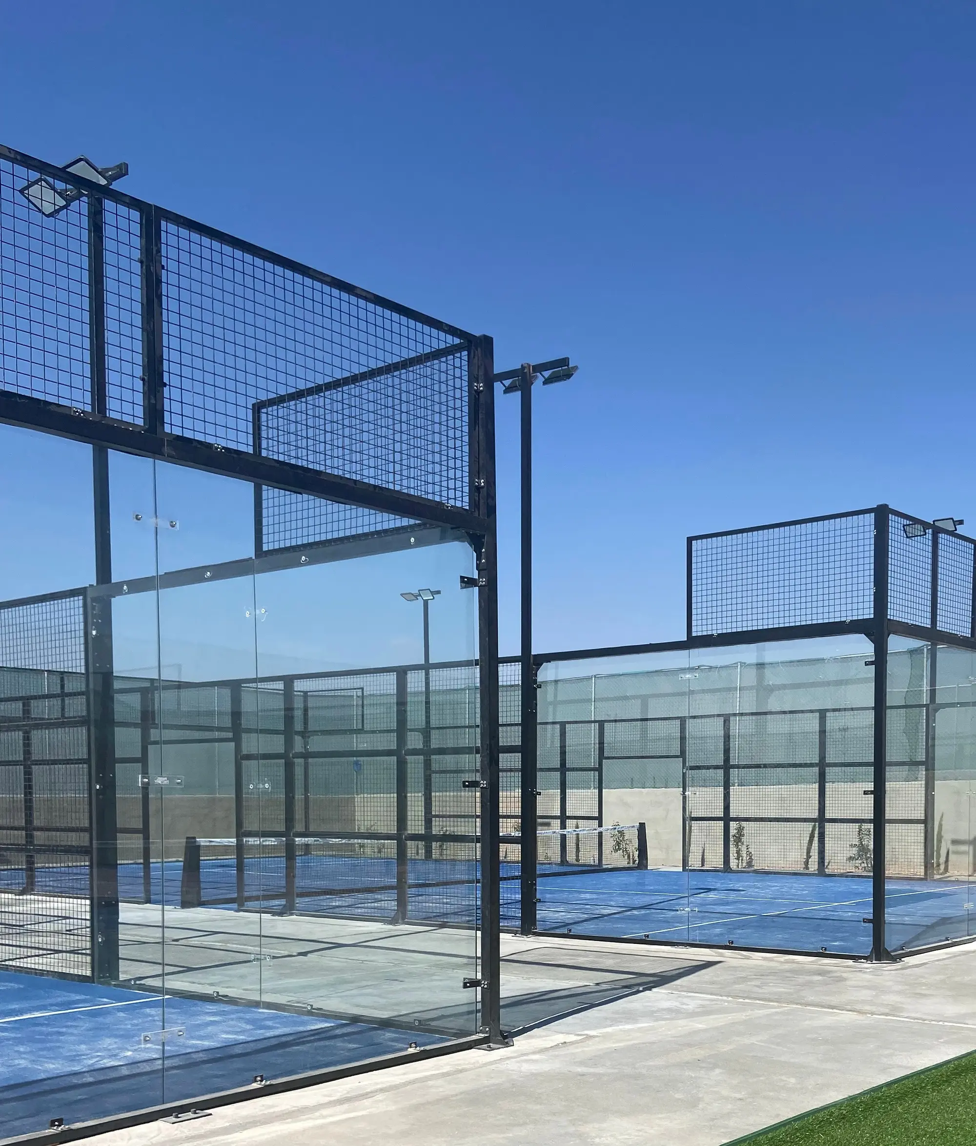 Glass walls and steel fence frames of the Baseline Courts courts